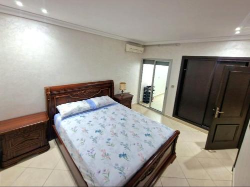 a bedroom with a bed and a sliding glass door at Nobilium in Meknès