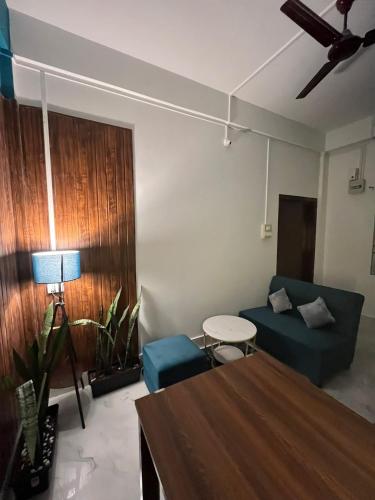 a living room with a couch and a table at Midtown Retreat in Dibrugarh