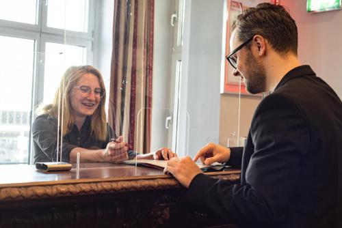 a man and a woman sitting at a table at Acom Hotel Berlin Kurfürstendamm in Berlin