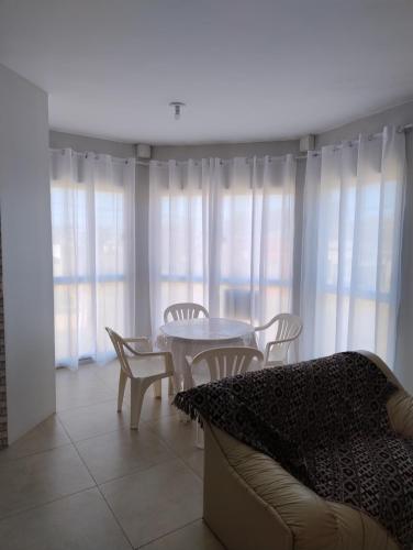 a living room with a table and chairs and a couch at Apartamento com Vista Panorâmica in São Gabriel