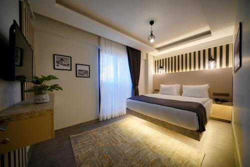 a hotel room with a bed and a window at newlife suites cappadocia in Nevsehir