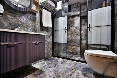 a bathroom with a toilet and a shower and a sink at newlife suites cappadocia in Nevsehir