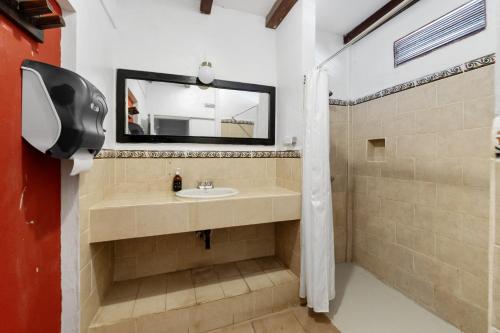 a bathroom with a sink and a mirror at Socialtel Granada in Granada
