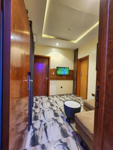 a large room with a marble floor and a door at Masters Class Apartments in Mama