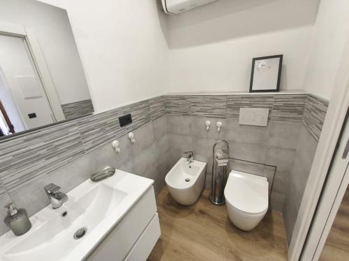 a white bathroom with a sink and a toilet at casa Mimi in Taggia