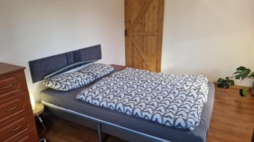 a bed with two pillows on it in a room at Wiejsko-Sielsko in Szczytna