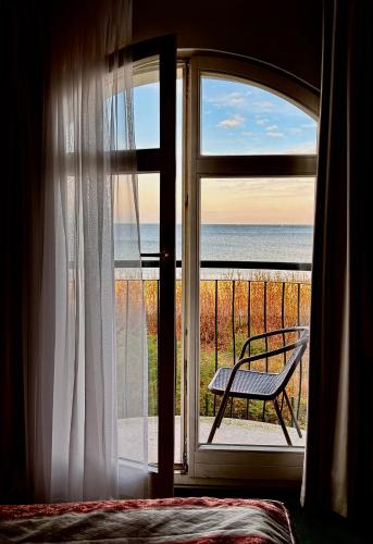 a bedroom window with a view of the ocean at Hotel Lival in Gdańsk