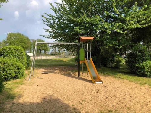 a playground with a slide in a park at Bungalow "CONFORT" PUY duFOU 2CH-5pers 720FA in La Boissière-de-Montaigu