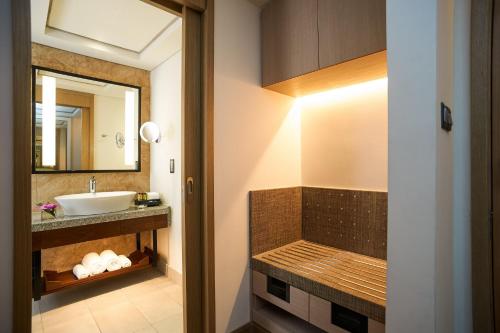 a bathroom with a sink and a mirror at Amari Johor Bahru in Johor Bahru