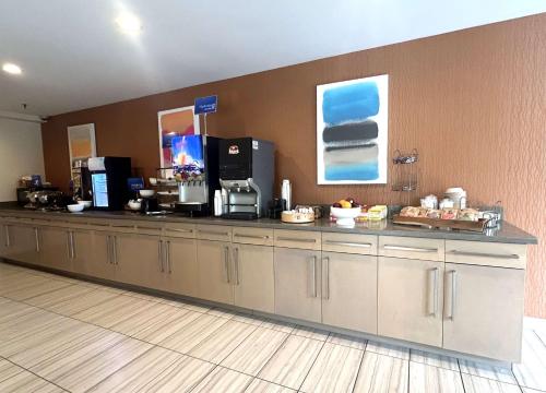a kitchen with a long counter with a counter at Best Western Erie Inn & Suites in Erie