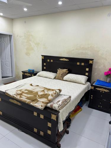 a bedroom with a large bed in a room at Aqua pura Lodges By Ansar Qureshi in Murree