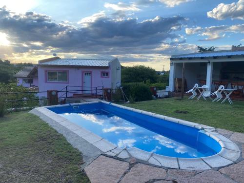 a swimming pool in the yard of a house at Cabañas & Apart Yki Shamuaika in Capilla del Monte