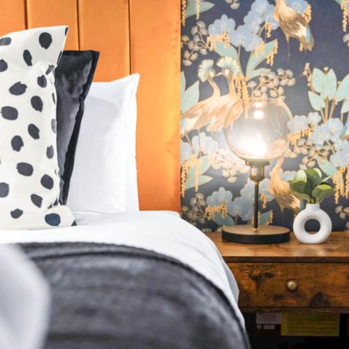 a bed with a pillow and a lamp on a table at Three Bedroom House - City Centre - Garden - Parking 12W in Birmingham