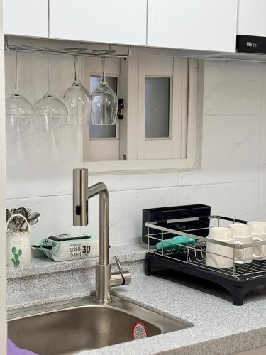 a kitchen with a sink and a counter top with glasses at Forest SB02 in Seoul
