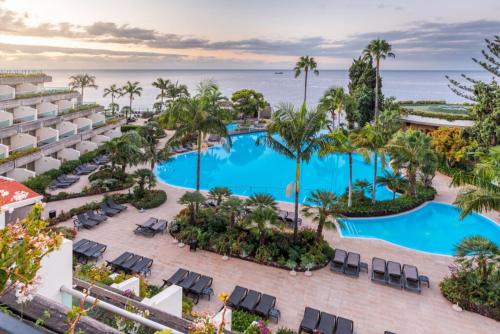 an aerial view of the pool at the resort at Pestana Madeira Beach Club in Funchal