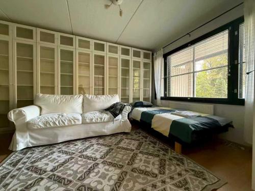 a living room with a couch and a window at Nordic Nest B in Vantaa
