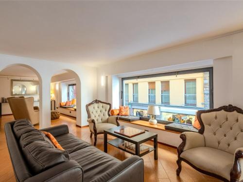 a living room filled with furniture and a large window at B&B Hotel Firenze Pitti Palace al Ponte Vecchio in Florence