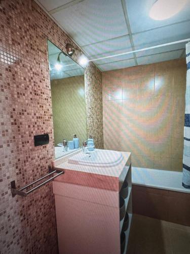 a bathroom with a sink and a mirror at Large terrace and views in Retamar