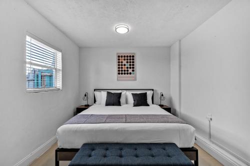 a white bedroom with a large bed and two windows at Cozy Hollywood Private Pool Retreat - Ping pong in Hollywood