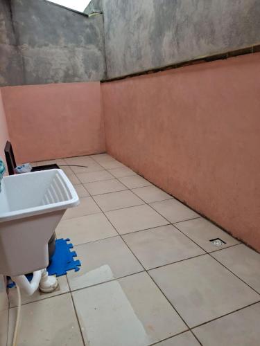 ein Bad mit einem Waschbecken und Fliesenboden in der Unterkunft Casa completa Beto Carrero in Penha