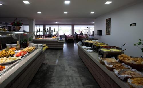 a buffet line with many different types of food at Resort Internacional DiRoma in Caldas Novas