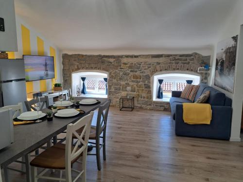 a kitchen and living room with a table and chairs at The way to trieste bikes storage in Trieste