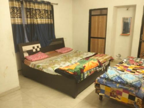 a bedroom with two twin beds and a window at Gurukrupa Home stay in Rājpīpla