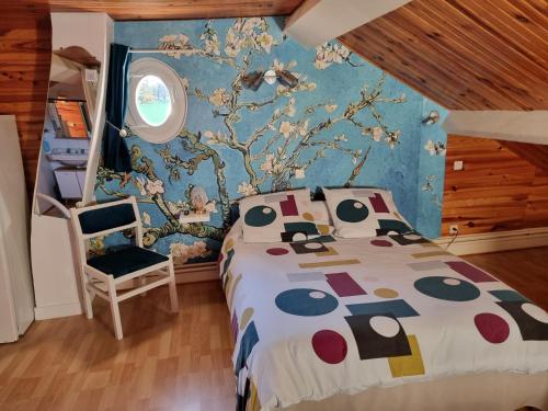 a bedroom with a bed and a tree mural at Chambres à l'Orée du bois in Souancé-au-Perche