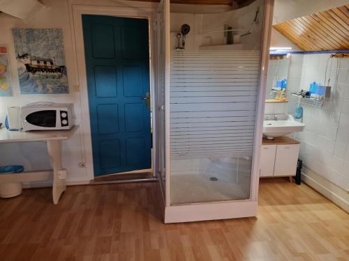a bathroom with a shower with a glass door at Chambres à l'Orée du bois in Souancé-au-Perche