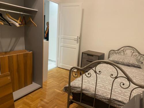 een slaapkamer met een bed, een spiegel en een deur bij Chambre privée design, 8 min du Parc des Prince et de Roland Garros et à 4 min du métro 9 in Boulogne-Billancourt