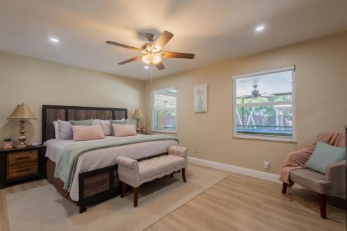 a bedroom with a bed and a ceiling fan at Family Oasis at Sunrise Private Pool, Game, Cardio, Grill, Work & Play in Sunrise