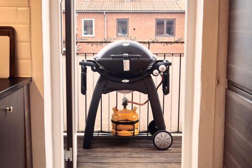 a baby carriage with a pumpkin on a porch at Cozy one bedroom apartment with balcony in Copenhagen
