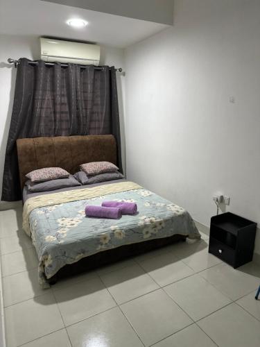 a bed with two pillows on it in a room at PakyaZ Homestay in Kuching