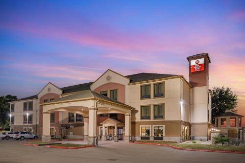 a hotel with a clock tower in a parking lot at Best Western Plus North Houston Inn & Suites in Houston