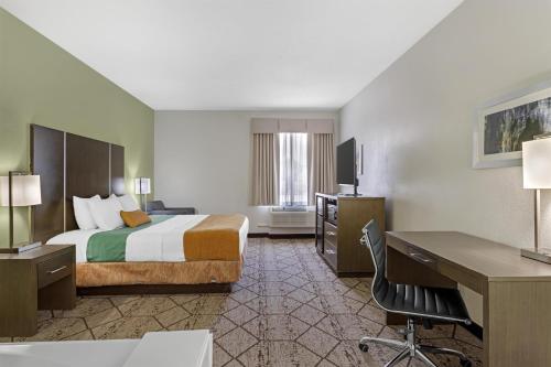 a hotel room with a bed and a desk at Best Western Plus North Houston Inn & Suites in Houston