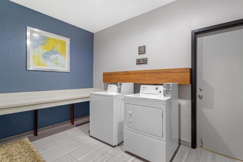 a laundry room with a washer and dryer at Best Western Plus North Houston Inn & Suites in Houston