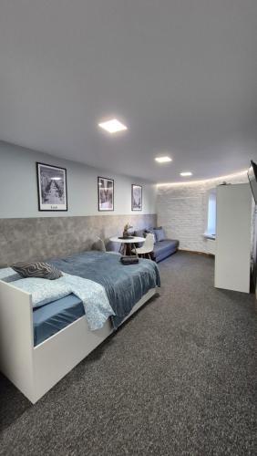 a bedroom with a bed and a table in it at Apart Complex Green Rewolucji 27 in Łódź