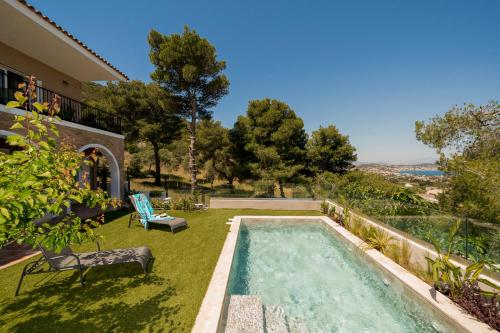 a swimming pool in the yard of a house at Villa Calma by A&D Properties in Porto Rafti