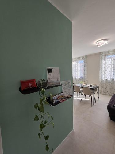 a living room with a table and a plant on a wall at La finestra sul Naviglio in Gaggiano
