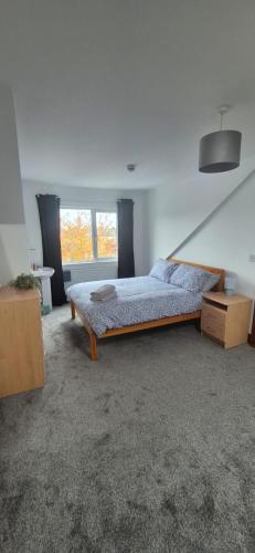 a bedroom with a bed and a window at Private Room in Eglantine Avenue in Central Belfast in Belfast