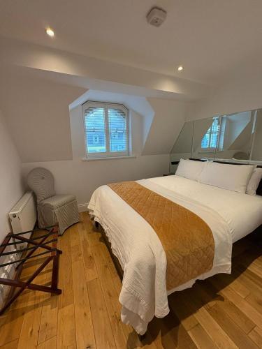 a bedroom with a large bed and a window at Gilberts Townhouse in Cobh