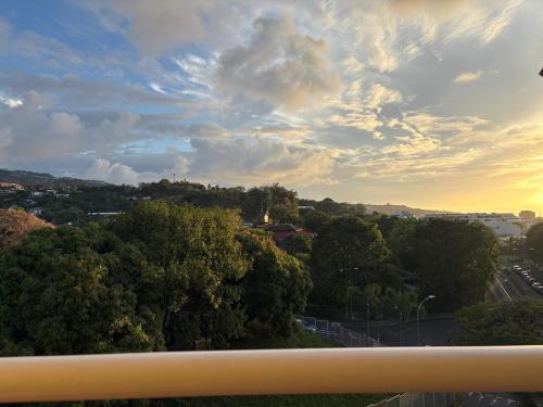 a view of a city with trees and a cloudy sky at Hinahei in Papeete