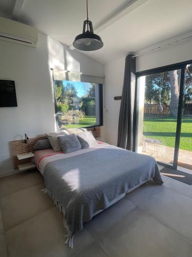 a bedroom with a large bed and a large window at La chambre de Laura in Castelnau-le-Lez