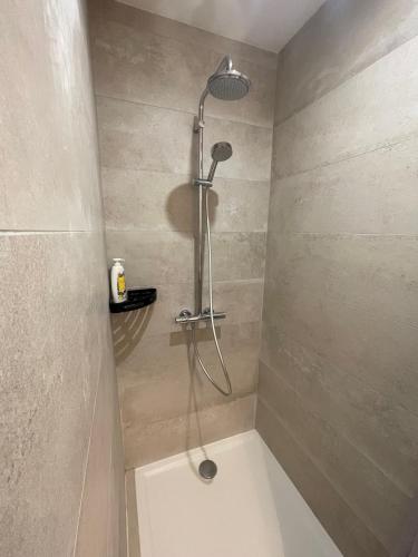 a shower with a shower head in a bathroom at La chambre de Laura in Castelnau-le-Lez