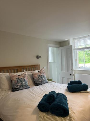 a bed with towels sitting on top of it at The Butler's Flat at Solsgirth Home Farm in Dollar