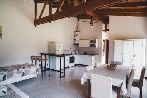 a kitchen and dining room with a table and chairs at Check and Home - Chapa - 5 huéspedes con patio y parrilla in Chapadmalal