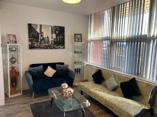 a living room with a couch and a table at 2 Bedroom Flat Sun in town Center Wellingborough in Wellingborough