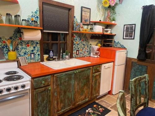 a kitchen with a sink and a stove at Go Glamping in Athens, Georgia, in this Cozy Tiny House for Four in Athens