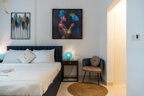 a bedroom with a bed and a chair at Yas Island 1BR - Blue Sapphire Luxe Escape in Abu Dhabi