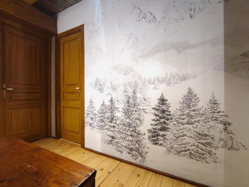 a wall with a mural of trees and snow at AC Apartaments Tarter Chalet in El Tarter